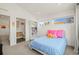 Bright bedroom featuring white walls, a cozy bed, and modern windows at 536 S Vine St, Denver, CO 80209