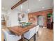 Open-concept dining room featuring a wooden table, brick wall, and lots of natural light at 536 S Vine St, Denver, CO 80209