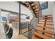 Stairway landing leading to an open-concept living area with stylish modern railings and a garage door at 536 S Vine St, Denver, CO 80209