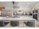 Bright kitchen featuring a large island with seating, stainless steel appliances, and modern light wood cabinets at 536 S Vine St, Denver, CO 80209