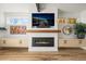 Cozy living room showcasing a fireplace, built-in shelving, hardwood floors, and a large screen television at 536 S Vine St, Denver, CO 80209