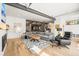 Spacious living room featuring hardwood floors, a comfortable sectional, and open flow to the kitchen at 536 S Vine St, Denver, CO 80209