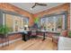 Home office with brick accent walls, large windows offering natural light, and hardwood flooring at 536 S Vine St, Denver, CO 80209