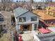 Backyard aerial view shows a modern home with a patio, red furniture, and fresh landscaping at 536 S Vine St, Denver, CO 80209