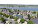 Stunning aerial view of a lakeside community featuring well-maintained homes and lush green trees at 10181 E 112Th Way, Commerce City, CO 80640