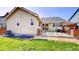 Backyard featuring a concrete patio with a built-in grill and grass area, great for outdoor activities at 10181 E 112Th Way, Commerce City, CO 80640