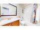 Bathroom featuring a single sink, wood vanity, and shower-tub combination with modern decor at 10181 E 112Th Way, Commerce City, CO 80640