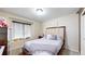 Comfortable bedroom with plush carpeting, dark wooden furnishings and modern window coverings at 10181 E 112Th Way, Commerce City, CO 80640