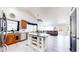 Bright open-concept kitchen featuring a kitchen island with seating and modern amenities at 10181 E 112Th Way, Commerce City, CO 80640