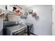 Modern laundry room with gray washer and dryer, shelving, and decorative wall storage for an organized space at 10181 E 112Th Way, Commerce City, CO 80640