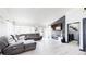 Spacious living room featuring modern flooring, recessed lighting, and a cozy feel at 10181 E 112Th Way, Commerce City, CO 80640