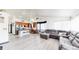Open-concept living space with modern flooring, kitchen island, and a cozy seating area at 10181 E 112Th Way, Commerce City, CO 80640