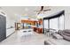 Bright open-concept space with kitchen island, modern appliances, and comfortable living area at 10181 E 112Th Way, Commerce City, CO 80640