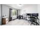 Bright office space with hardwood floors, large window, and contemporary black and white patterned curtains at 10181 E 112Th Way, Commerce City, CO 80640