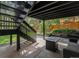 Under-deck patio and backyard area featuring a firepit, lounge seating, and mature landscaping at 11022 Trailrider Pass, Littleton, CO 80127