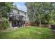 Extensive backyard featuring well-maintained lawn, fire pit area, and spacious patio at 11022 Trailrider Pass, Littleton, CO 80127