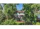 Spacious backyard features two-story deck, mature trees, and lush landscaping at 11022 Trailrider Pass, Littleton, CO 80127
