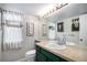 Traditional bathroom with green vanity, white sink, and decorations at 11022 Trailrider Pass, Littleton, CO 80127
