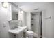 Bathroom features updated sink and vanity, and shower with classic striped curtain at 11022 Trailrider Pass, Littleton, CO 80127
