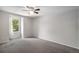 This is a bedroom with a neutral carpet, gray walls, a ceiling fan, and a window at 11022 Trailrider Pass, Littleton, CO 80127