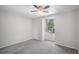 This is a bedroom with a neutral carpet, gray walls, and a window at 11022 Trailrider Pass, Littleton, CO 80127