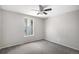 This is a bedroom with a neutral carpet, gray walls, and a window at 11022 Trailrider Pass, Littleton, CO 80127