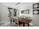 Contemporary dining room with a wooden table, modern lighting, and sheer curtains at 11022 Trailrider Pass, Littleton, CO 80127