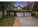 Charming two-story home with a well-manicured lawn and attached two car garage at 11022 Trailrider Pass, Littleton, CO 80127