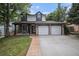 Charming two-story home with a well-manicured lawn and attached two car garage at 11022 Trailrider Pass, Littleton, CO 80127