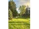 Picturesque view of park with a winding path, lush grass, and mature trees at 11022 Trailrider Pass, Littleton, CO 80127