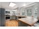 Bright kitchen with hardwood floors, stainless steel appliances, and a breakfast bar at 11022 Trailrider Pass, Littleton, CO 80127