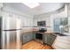 Functional kitchen with a stainless steel refrigerator, range, and ample counter space at 11022 Trailrider Pass, Littleton, CO 80127