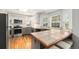 Bright kitchen features tile counters, gray cabinets, stainless steel appliances, and hardwood floors at 11022 Trailrider Pass, Littleton, CO 80127