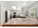 Bright kitchen features tile counters, gray cabinets, stainless steel appliances, and hardwood floors at 11022 Trailrider Pass, Littleton, CO 80127