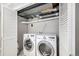 Laundry room features front load washer and dryer with access to utility connections and closet at 11022 Trailrider Pass, Littleton, CO 80127