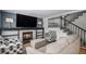 Elegant living room featuring a fireplace, flat screen television, and staircase access at 11022 Trailrider Pass, Littleton, CO 80127