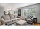 Inviting living area with a comfortable sofa and modern furnishings, with access to kitchen at 11022 Trailrider Pass, Littleton, CO 80127
