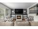 Comfortable living room featuring a fireplace, TV, with two armchairs and neutral sofa at 11022 Trailrider Pass, Littleton, CO 80127