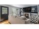 Cozy living room with fireplace, a TV, modern furniture, and an exterior door at 11022 Trailrider Pass, Littleton, CO 80127