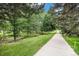 Scenic community sidewalk with lush landscaping, ideal for a leisurely stroll at 11022 Trailrider Pass, Littleton, CO 80127