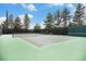 Outdoor tennis court with green surface, black fence, and nets on a sunny day at 11022 Trailrider Pass, Littleton, CO 80127