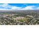 Aerial view of property located in neighborhood near a school and open land and sky at 1261 Eagle St, Aurora, CO 80011