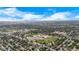 Aerial view of property located in neighborhood near a school and open land and sky at 1261 Eagle St, Aurora, CO 80011