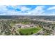 Aerial view of a property in a neighborhood near a school and large medical complex at 1261 Eagle St, Aurora, CO 80011