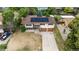 Aerial view of a two-story home with an attached garage, solar panels and landscaping at 1261 Eagle St, Aurora, CO 80011