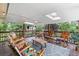 Charming back deck featuring skylights, wood floor, a wood table and six wood rocking chairs at 1261 Eagle St, Aurora, CO 80011