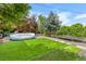 Large backyard with green lawn, inground pool, trampoline and deck at 1261 Eagle St, Aurora, CO 80011
