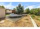 Large backyard with deck, trampoline, yard waste and green lawn at 1261 Eagle St, Aurora, CO 80011