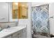 Bathroom with patterned shower curtain, white vanity, and neutral walls at 1261 Eagle St, Aurora, CO 80011