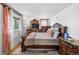 Well-lit bedroom featuring a plush rug, a wooden dresser and lots of natural light at 1261 Eagle St, Aurora, CO 80011
